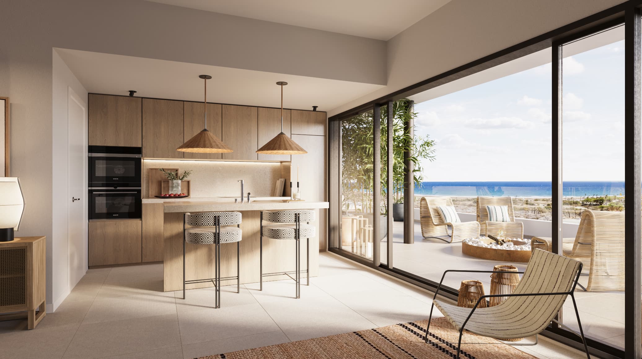 COCINA-ATICO-1 - MiraCasa Modern kitchen with a wood island, two woven pendant lights, and floor-to-ceiling mirrors of the beach outside through glass doors, open to a patio.