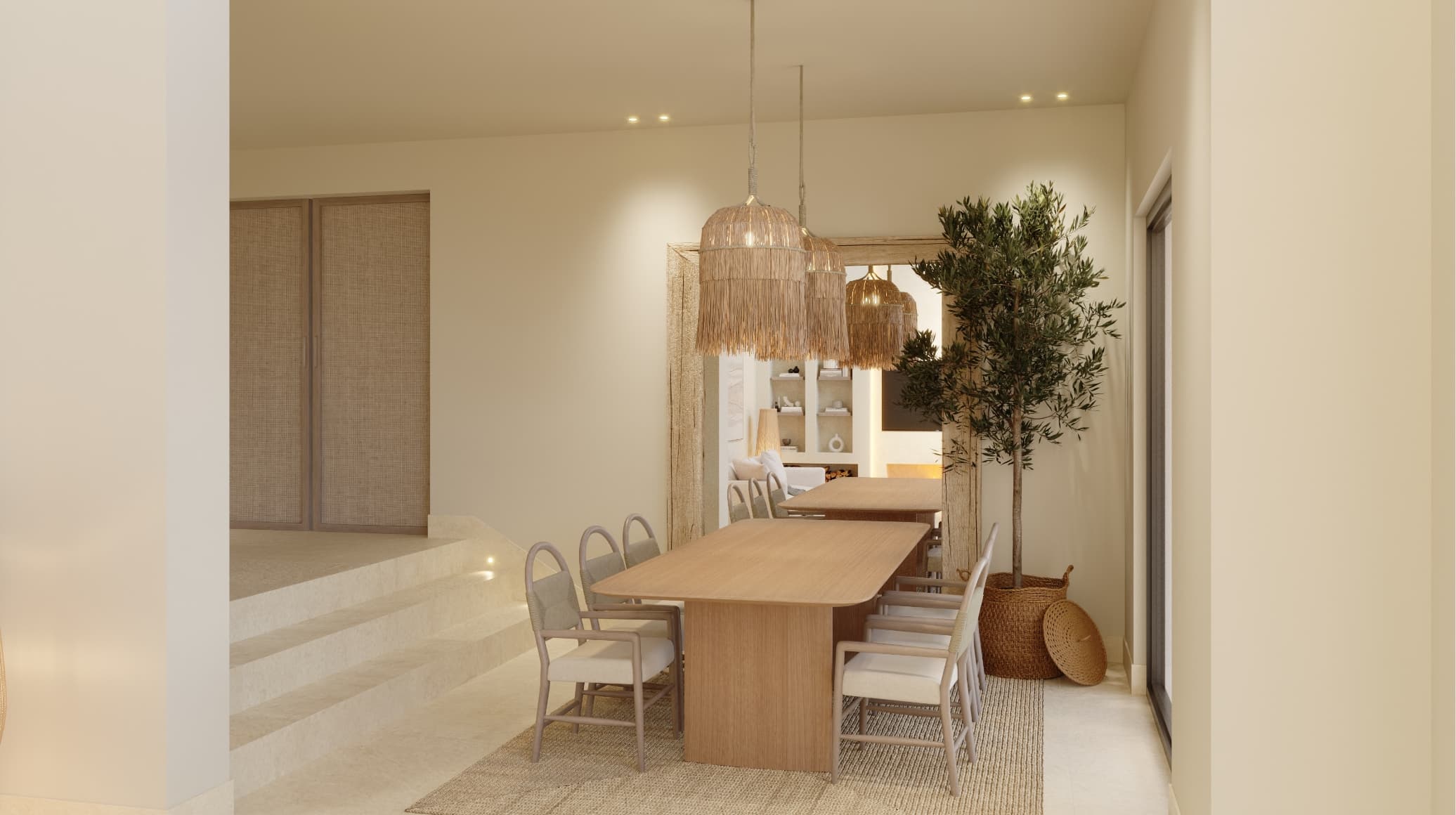 Mediterraneo_comedor - MiraCasa Long wooden dining table with light gray chairs beneath woven rattan pendant lights in a neutral-toned interior showroom, with a tall potted plant nearby.