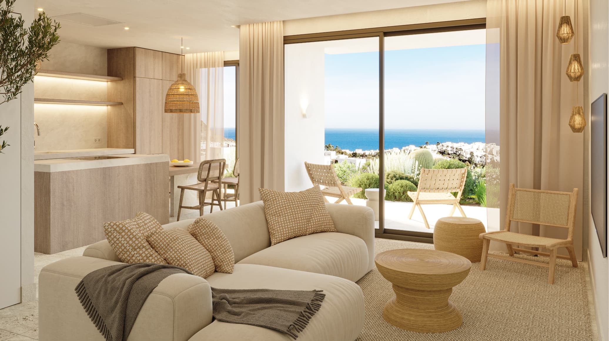 Bright living room with beige furniture and a view of the ocean through large glass doors.