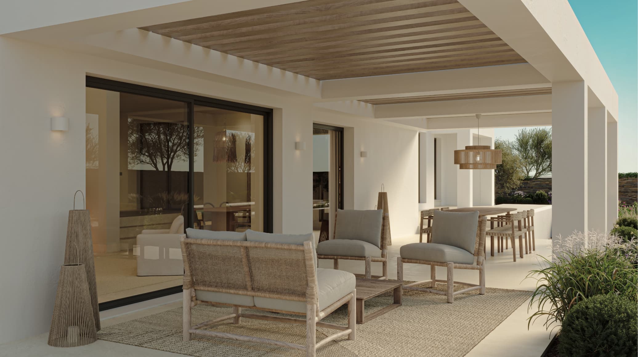 Mediterraneo_terraza - MiraCasa Modern covered patio of a white house with beige wicker seating, glass sliding doors, and a wooden pergola ceiling.