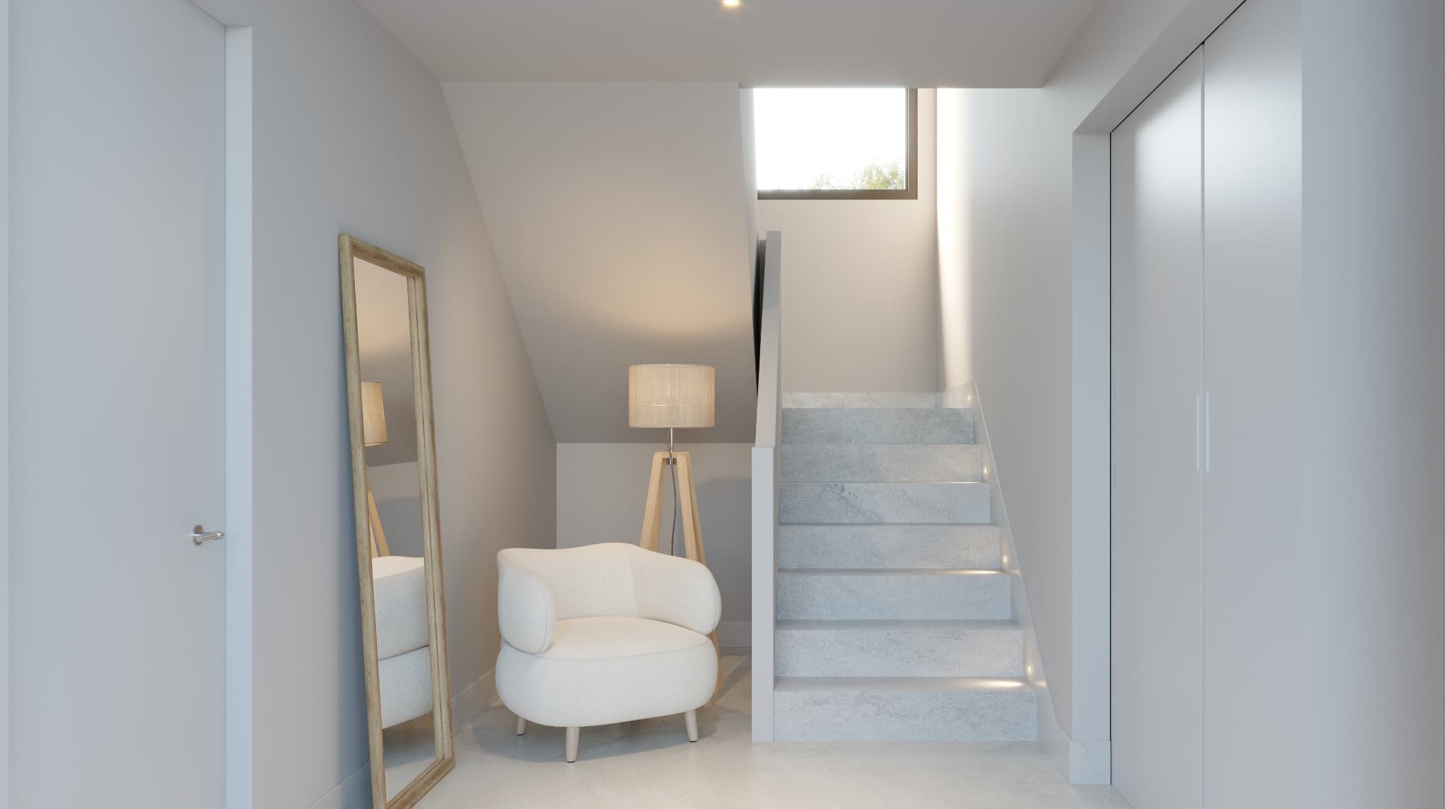 Natural_entrada - MiraCasa Small modern hallway with pale gray walls, a white upholstered chair, a floor lamp, leaning mirror, and stairs to the right.
