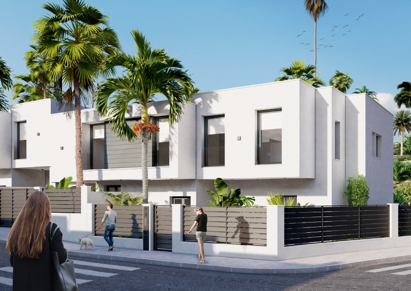 Oasis-Los-Pinos-II-Inalgra-Huercal-de-Almería - MiraCasa Modern two-story white villa with palm trees and a fenced yard on a sunny street; pedestrians pass by with a small dog nearby.