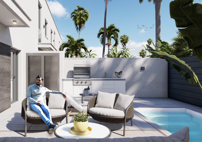 Oasis-Los-Pinos-II-Inalgra-Huercal-de-Almería-7 - MiraCasa Man relaxing on an outdoor lounge set in a modern backyard with a built-in grill, counter, and palm trees nearby.