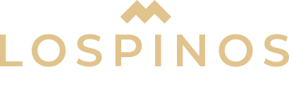 Logo for Los Pinos in beige wordmark with a stylized mountain above the text on a dark background.