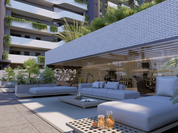 Escena 7_1 - copia - copia - copia - MiraCasa Modern outdoor lounge with gray sectional sofas, glass walls, and potted plants near a gym building.