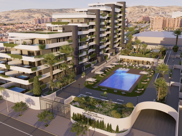 YGABSA AEREA 01_4 - copia - MiraCasa Modern apartment complex with white balconies and greenery, a central pool area, and palm trees set against a mountainous backdrop from an elevated perspective.